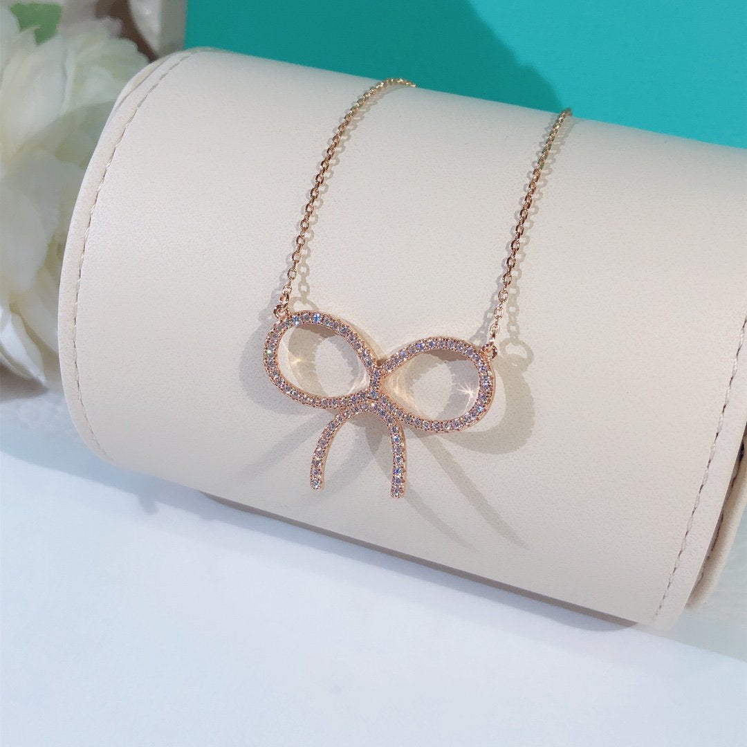 [Corinne]CLAW SET RHODIUM PLATED BOW NECKLACE