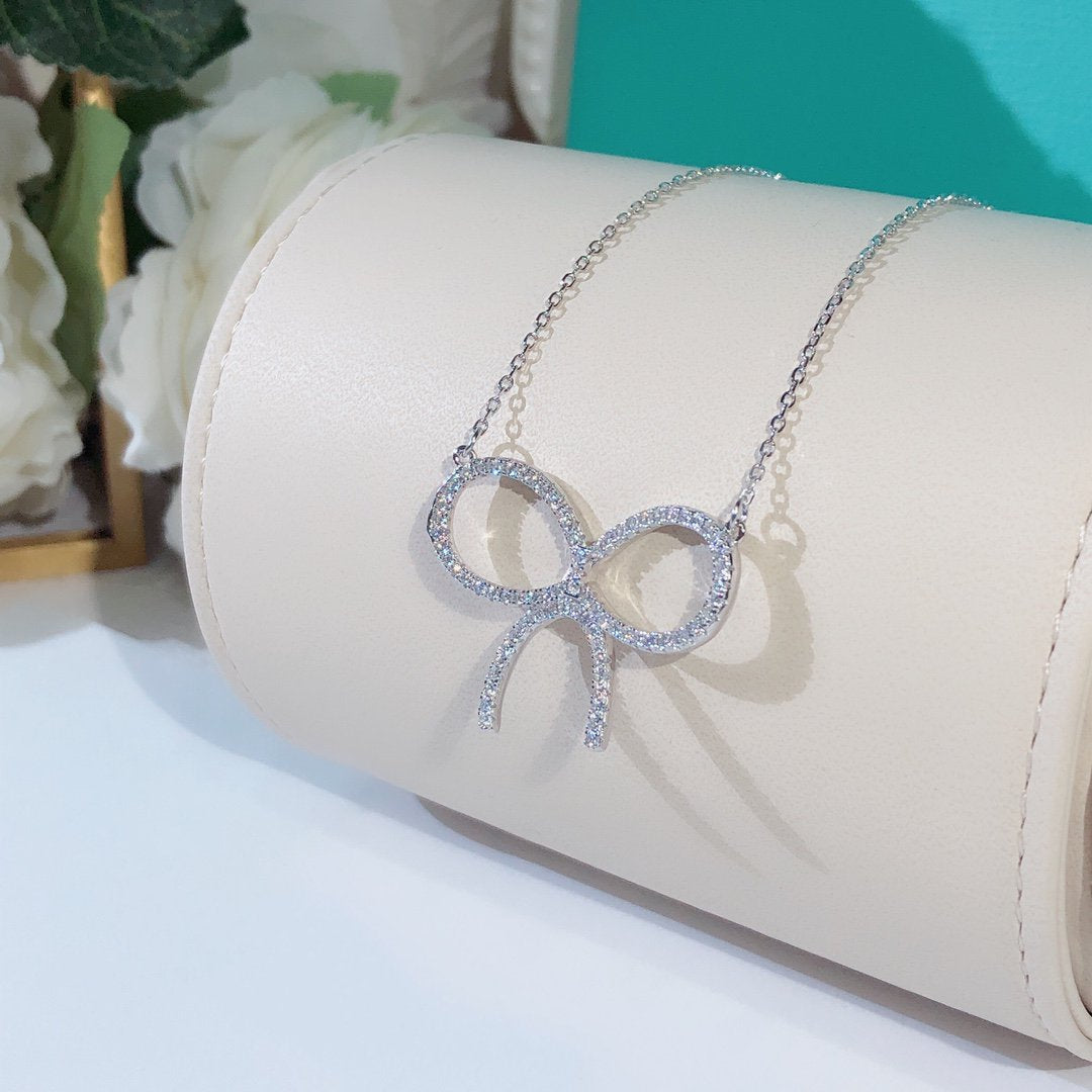 [Corinne]CLAW SET RHODIUM PLATED BOW NECKLACE