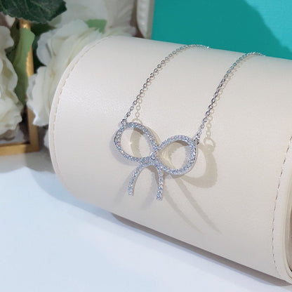 [Corinne]CLAW SET RHODIUM PLATED BOW NECKLACE